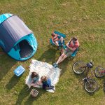 family enjoying camping tents cycling at Forest Glade