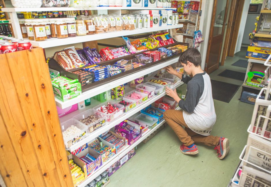 boy buying sweets in forest glade shop