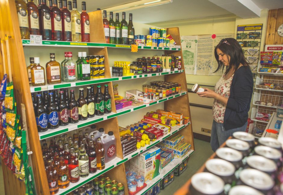 lady browsing items in the on-site shop at forest glade